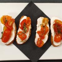 Bruschetta · Toasted ciabatta bread, spread with ricotta cheese, roasted heirloom cherry tomatoes, garlic...