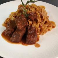 Fettuccine Short Ribs · Rosemary infused fettuccine sauteed with braised short ribs in a red wine and plum tomato sa...