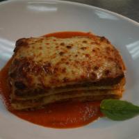 Lasagna All Emiliana · Baked pasta layered with meat sauce, béchamel, mozzarella and Parmesan cheese.