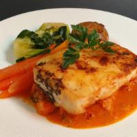 Chilean Sea Bass Alla Catalana · Pan seared, served with lobster meat in a cognac sauce. With seasonal vegetables and roasted...