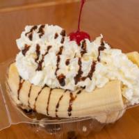 Banana Split · Three scoops of ice cream in between a banana with chocolate syrup, whipped cream, and a che...