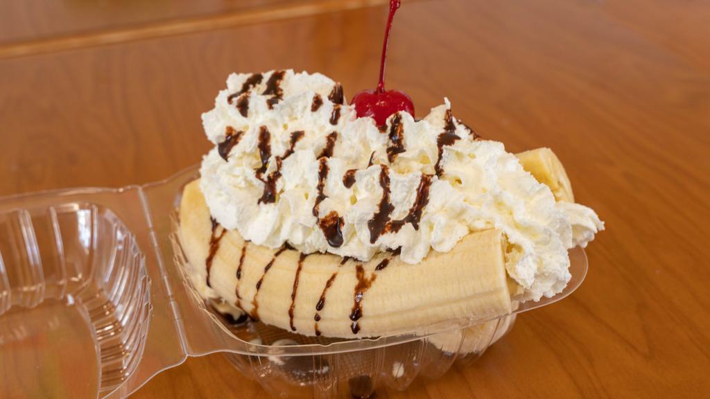Banana Split · Three scoops of ice cream in between a banana with chocolate syrup, whipped cream, and a cherry.