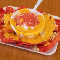 Chorreada · Corn cocktail with choice of chips with nacho cheese over everything.