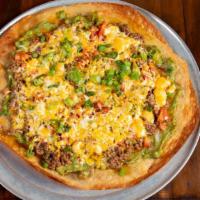 Mexican Pizza · Crisp flour tortilla layered with cheese, green chiles, fresh tomatoes, guacamole, and your ...