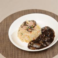 Jjajang Seafood Fried Rice · Shrimp, squid, vegetables and egg fried rice topped with Jjajang sauce.