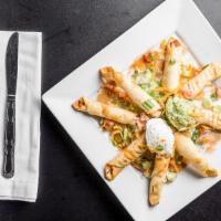 Chicken Taquitos · Crisp flour tortillas filled with our fresh tasty chicken. Garnished with tomatoes, onions, ...