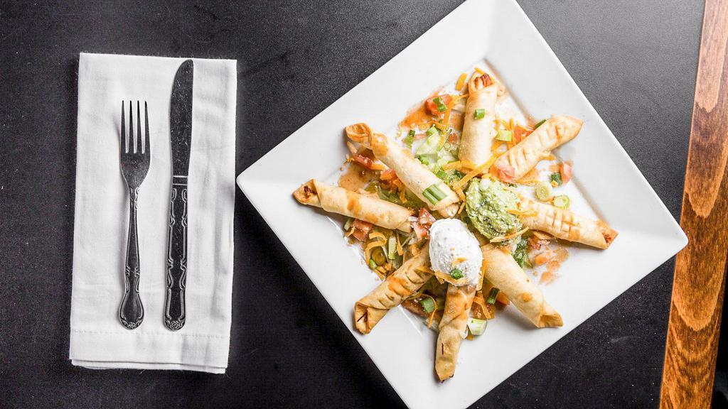 Chicken Taquitos · Crispy flour tortillas filled with our fresh tasty chicken. Garnished with tomatoes, onions, sour cream, guacamole.