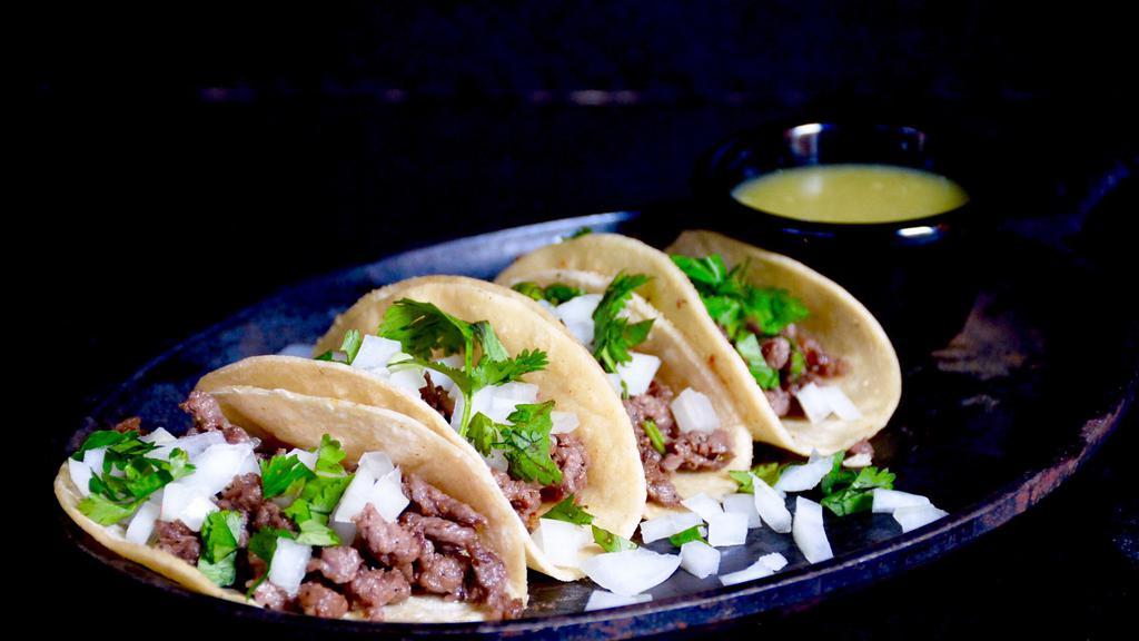 Street Tacos · Corn tortilla filled with your choice of meat, Chile Colorado topping, onions, cilantro, and green hot sauce on side.