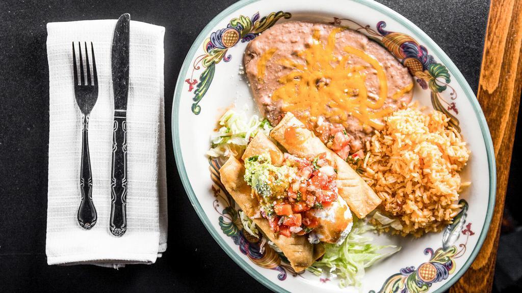 #11 Flautas · Three Deep fried corn tortilla filled with chicken, topped with guacamole, sour cream, and salsa. Served with rice and choice of refried or rancho beans.