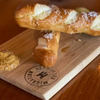 Pretzel Twists · Two bavarian-style pretzels with mustard, house made pickles, house made tillamook queso.
