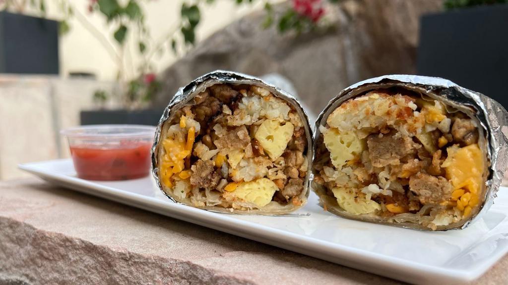 Vegan Breakfast Burrito · Warm tortilla filled with vegan eggs, sausage, tator tots, country gravy and melted cheese.  Served with salsa on the side.