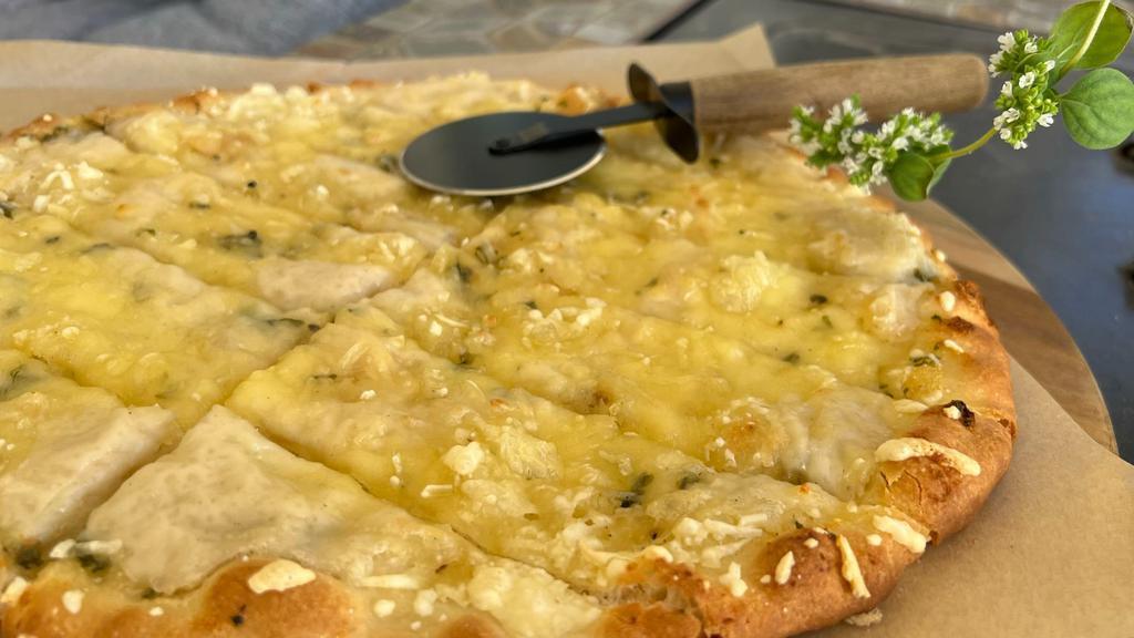 12” Garlic Bread With Melted Vegan Mozzarella · Topping includes vegan butter with fresh garlic, herbs and vegan mozzarella.