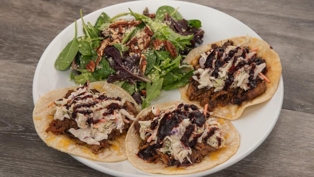Blackberry Ancho Pulled Pork Tacos · Corn Tortilla, Jack and Cheddar Cheese, House made Slaw and House Smoked Pulled Pork with Blackberry Ancho Sauce