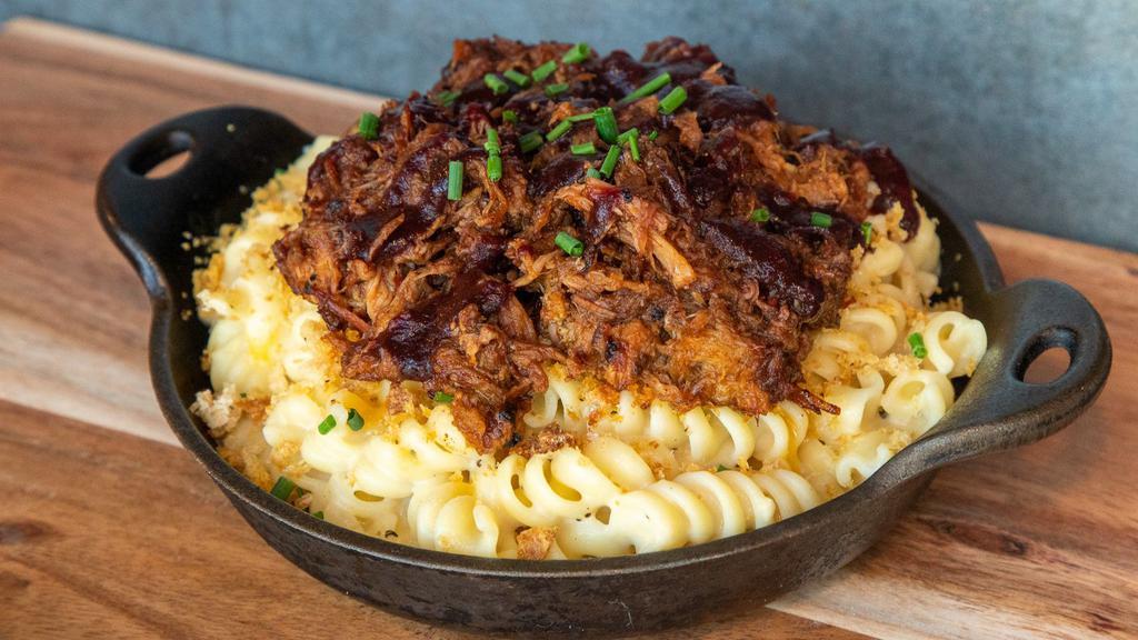 Pulled Pork Mac And Cheese · House Smoked Pulled Pork in Blackberry Ancho Sauce atop our House Mac and Cheese