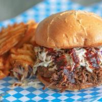 Chopped Brisket Sandwich · House Smoked Beef Brisket with Bruce's BBQ sauce and coleslaw. Served with Waffle Fries