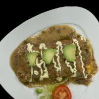 Pueblo Omelette · Bacon, Ham, Barbacoa, Onion, Monterrey and Cheddar Cheese and Smothered in Green Chile and S...