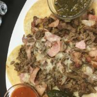 Alambre · A mix of Carne Asada, Bacon, Ham, and Onions Grilled together to perfection, topped with Whi...