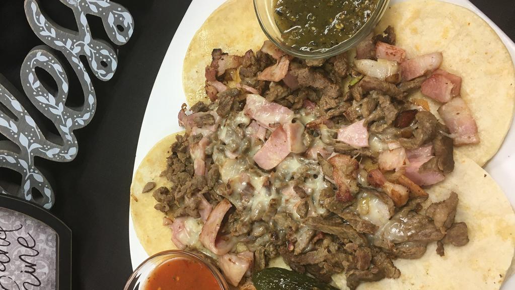 Alambre · A mix of Carne Asada, Bacon, Ham, and Onions Grilled together to perfection, topped with White Cheese and served with 10 Small Corn Tortilla and Salsas