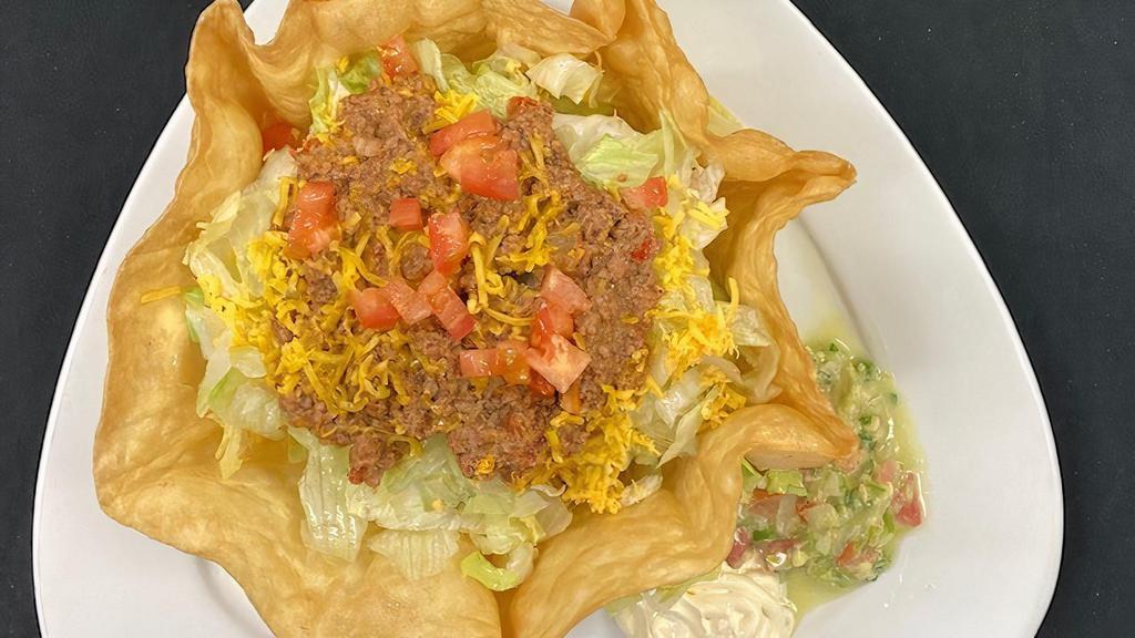 Taco Salad · Deep Fried Flour Shell Filled with Your Choice of Ground Beef, Barbacoa/ Shredded Beef or Shredded Chicken, Lettuce, Cheese, Tomatoes, Sour Cream and Guacamole