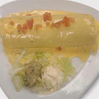 Tex-Mex Burrito · Your choice of Meat, Rice and Beans wrapped in a Flour Tortilla, topped with our Home Made C...