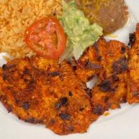 Pollo Parrilla  · Grilled Adobada Chicken Breast, Served with Rice, Beans, Guacamole and your choice of tortil...