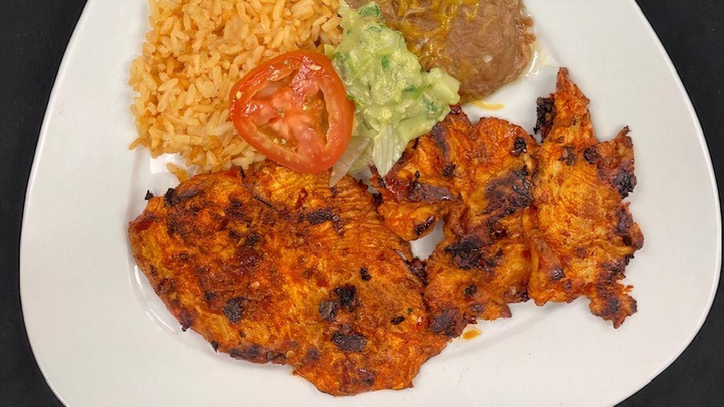 Pollo Parrilla  · Grilled Adobada Chicken Breast, Served with Rice, Beans, Guacamole and your choice of tortillas, garnished with lettuce and Tomato