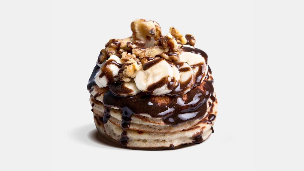 Chocolate Monster · Non-GMO Whole Grain Whey Protein Pancakes infused with Dark Chocolate Chips and topped with Bananas, Walnuts and Sugar Free Chocolate Protein Sauce!