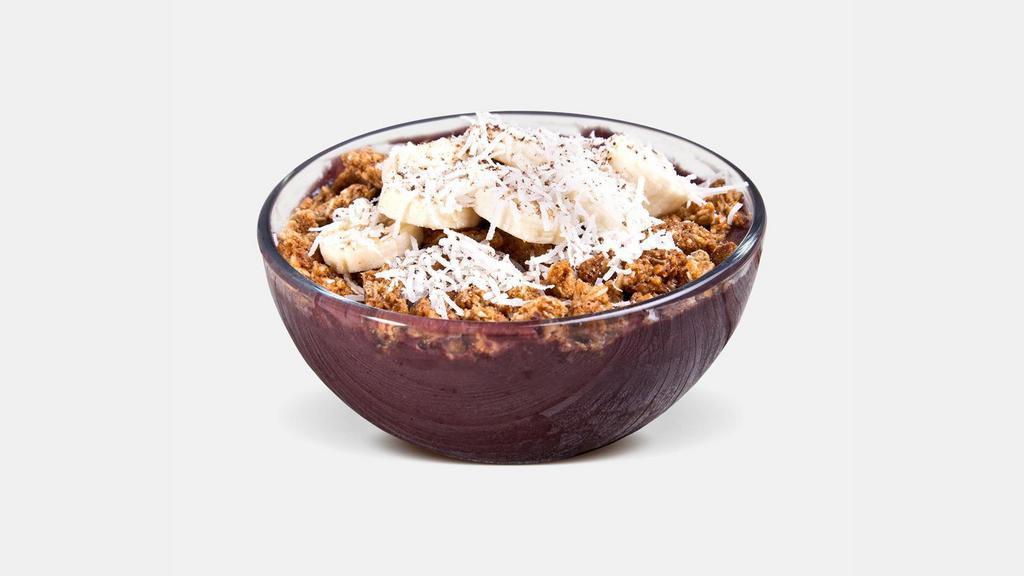 Tropical Acai Bowl · Organic Unsweetened Acai, Vanilla Whey, Pineapple, Banana, topped with Banana, Coconut Flakes, Granola & Flax Seeds.