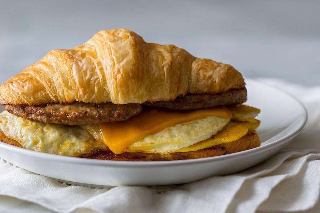 Meat, Egg, And Cheese Breakfast Croissant · Your choice of ham, sausage or bacon with American cheese and two fresh cracked eggs. Served on a European butter croissant.