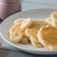 Kid'S Pancakes · 3 silver dollar size pancakes with a banana sliced over the top. Served with homemade carame...