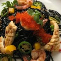 Pasta Pad Cha · Linguine pasta with black squid ink, cherry tomato, roasted chili paste, green peppercorns, ...