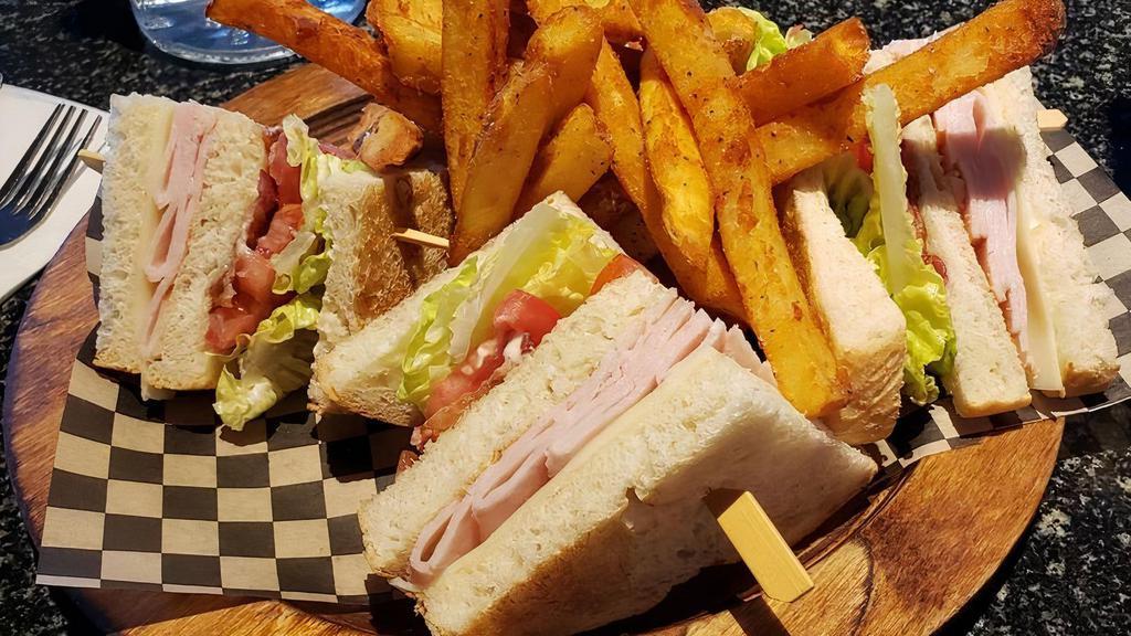 Club Deluxe · Smoked turkey, crisp bacon, lettuce, roma tomatoes, provolone & mayo on toasted sourdough with a choice of fries or garden salad
