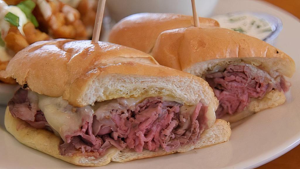 Prime Rib French Dip · thinly sliced fresh prime rib with swiss cheese on a fresh grilled hoagie roll, served any temperature, with au jus. A side of creamy horseradish sauce upon request.