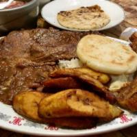 Churrasco Chapin · Grilled steak with green onion, black beans, sweet plantains, rice, cheese and sour cream. C...