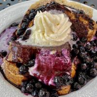 Lemon Blueberry French Toast · Thick sweet brioche dipped in vanilla cream topped with lemon blueberry cream, berry drizzle...