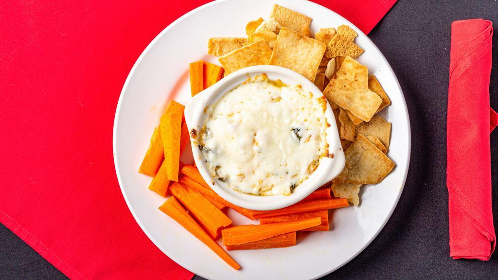 Artichoke Dip · House made spinach artichoke dip with sundried tomatoes and parmesan cheese served with pita chips and vegetables.