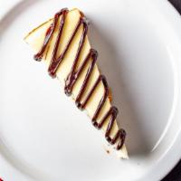 Cheesecake · Cheesecake drizzled with chocolate sauce.