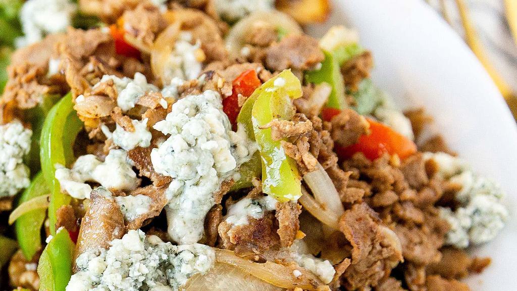 Steak 'N Blue · Romaine, Tomatoes, Walnuts, Thinly Sliced Ribeye Steak, Sauteed with Mushrooms, Mixed Peppers, Onions, Blue Cheese Crumbles, Sweet Vinaigrette.
