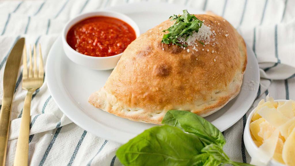 Build Your Own Calzone · Choose your favorite three ingredients from the traditional style pizza section. Ricotta and mozzarella included.