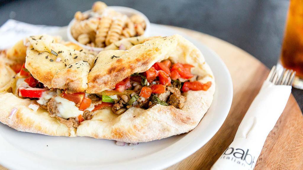 Steak Panino · Thinly sliced ribeye steak, mushrooms, mixed peppers, onions, mozzarella cheese, topped with bruschetta tomatoes. Served on foccacia.