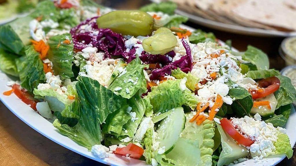 Greek Salad · Lettuce, cucumber, tomato, red cabbage, bell pepper, black olives, and feta cheese tossed in special dressing.