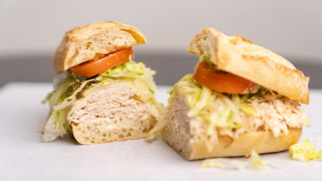 Turkey And Smoked Provolone  · Our house seasoned mayo, turkey and smoked provolone  toasted on a baguette with lettuce, tomato.