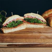 The Whoop Whoop · Tofurky, vegan pepperoni, greens, tomato, red onion, basil aioli, and oregano vin, served on...