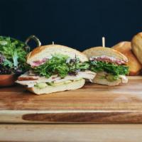 The California Turkey · Turkey, avocado, greens, tomato, red onion, basil aioli, and lemon vin, served on ciabatta.