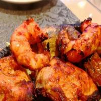 Tandoori Mixed Grill · Assorted kabobs of chicken, lamb, fish and shrimp on onion-bed in sizzler. Baked to order in...