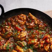 Chicken Bhuna · Boneless meat pieces cooked with onion, tomatoes, bell peppers, and spices.