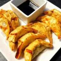 Pot Stickers (8 Pc) · Deep fried dumplings filled with ground chicken, vegetable, and served with sweet soy sauce.