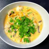 Tom Kha · Hot and sour coconut milk soup with lemon grass, lime leaves, mushrooms, galangal 
and cilan...