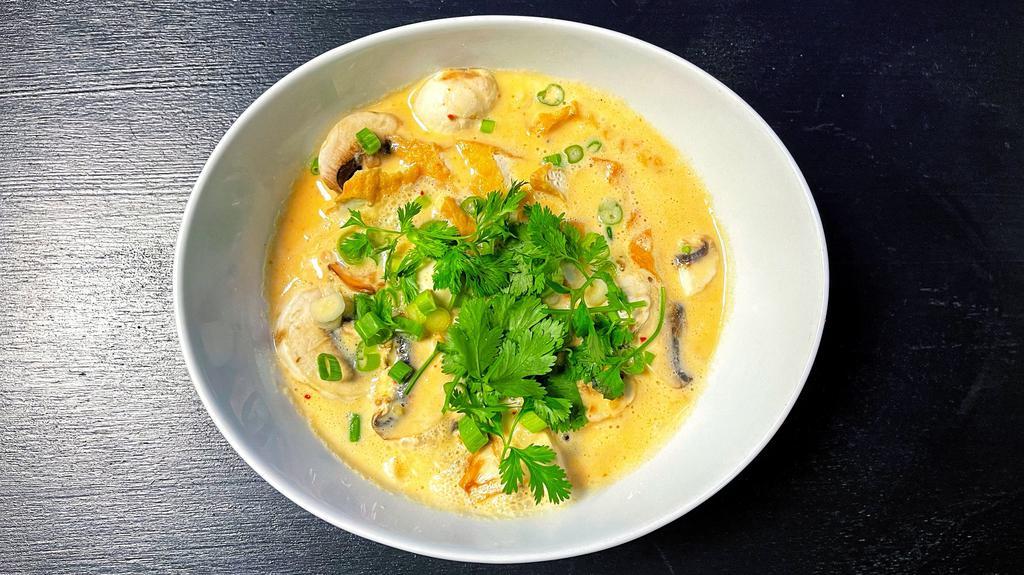 Tom Kha · Hot and sour coconut milk soup with lemon grass, lime leaves, mushrooms, galangal 
and cilantro.