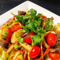Thai Beef Salad · Strips of beef marinated in lime juice, chili, onions, cilantro, carrots, cucumbers, tomatoe...